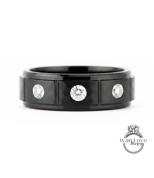 A black ring with three diamonds set in the center.