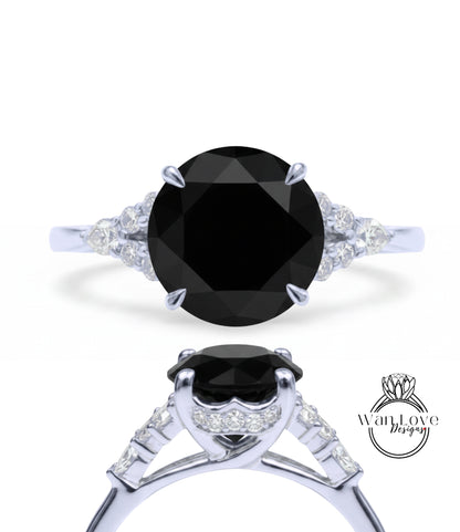A silver ring with a large black diamond as the centerpiece, surrounded by smaller diamonds.