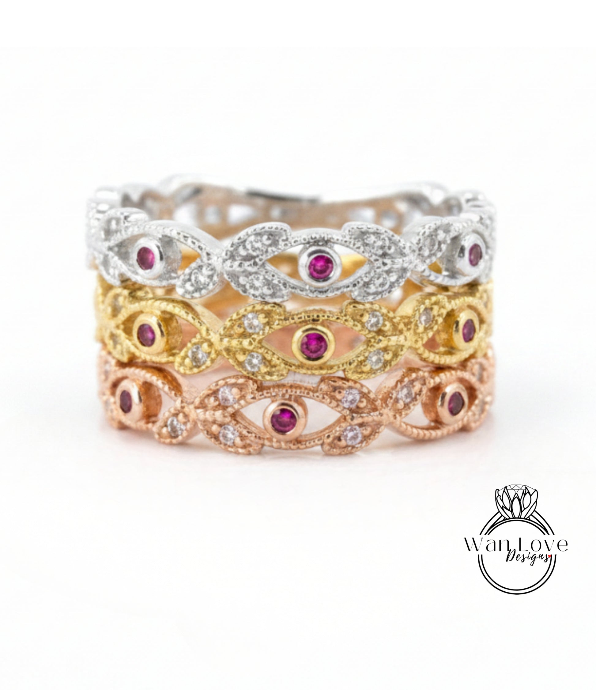 A ring with three distinct layers, each featuring a unique design and color of gemstones. The topmost layer is silver, the middle layer is gold, and the bottom layer is pink. The ring is adorned with small gemstones, adding to its elegance and charm.