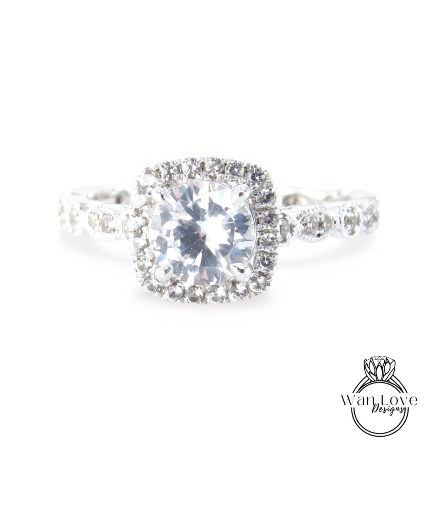 A close-up view of a diamond engagement ring with a large, brilliant-cut diamond at the center, surrounded by smaller diamonds and set in a halo of smaller diamonds.