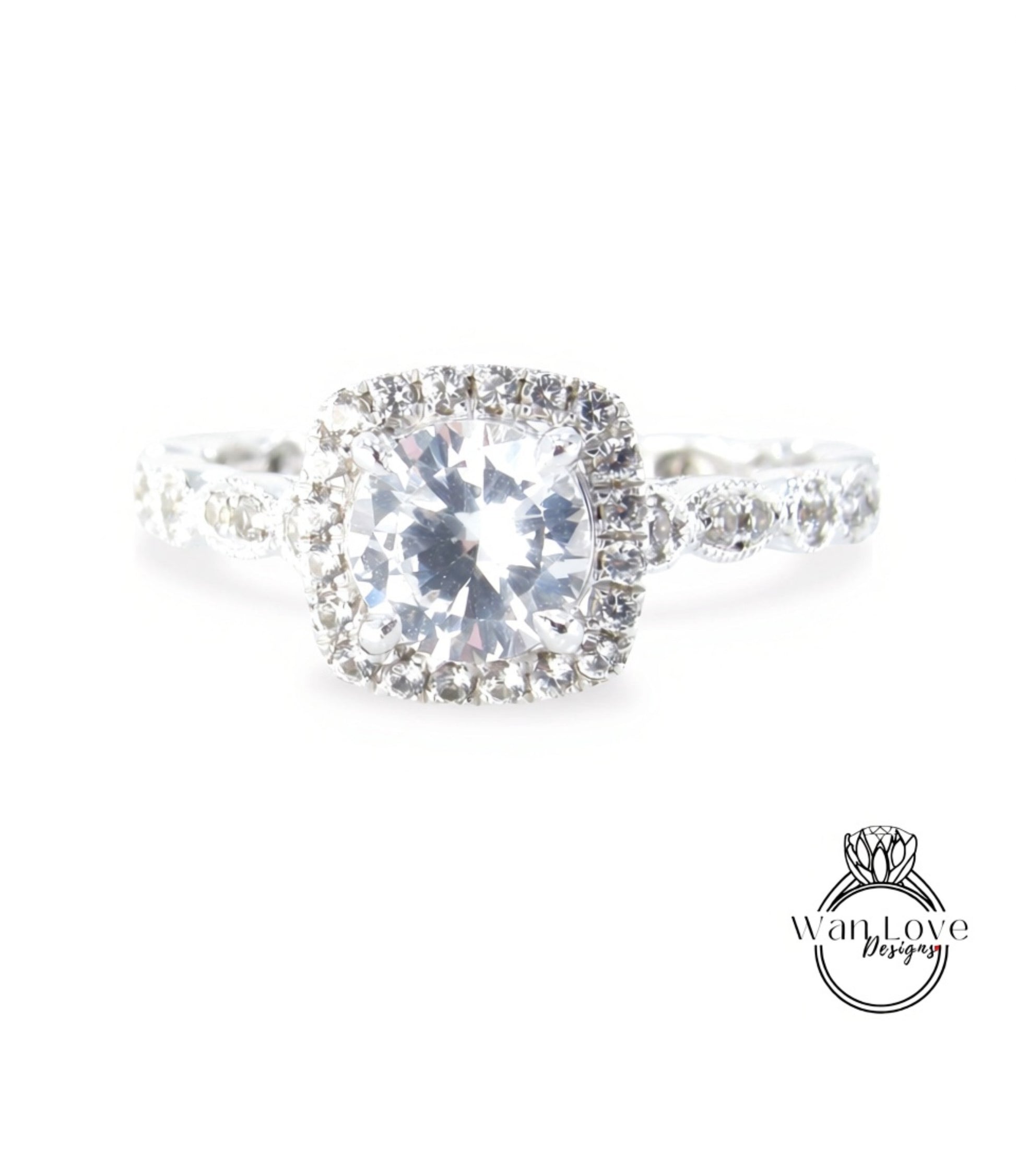 A close-up view of a diamond engagement ring with a large, brilliant-cut diamond at the center, surrounded by smaller diamonds and set in a halo of smaller diamonds.