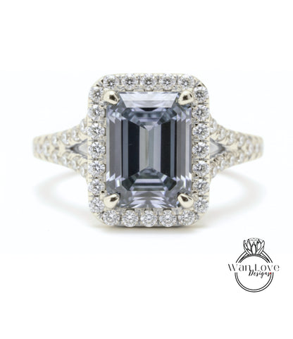 A stunning diamond engagement ring with a large, rectangular-shaped gemstone set in a halo of smaller diamonds.