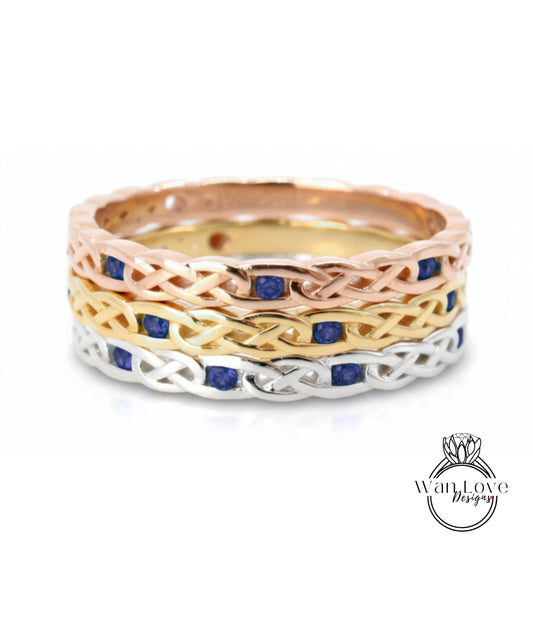 A ring with a Celtic knot design and blue gemstones.