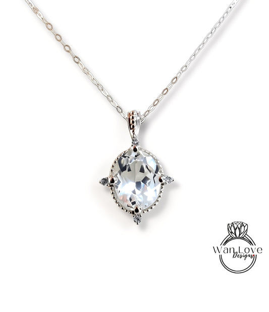 A silver necklace with a large, clear gemstone pendant.