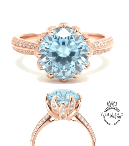 A rose gold ring with a large blue gemstone, likely a diamond, set in a scalloped band.