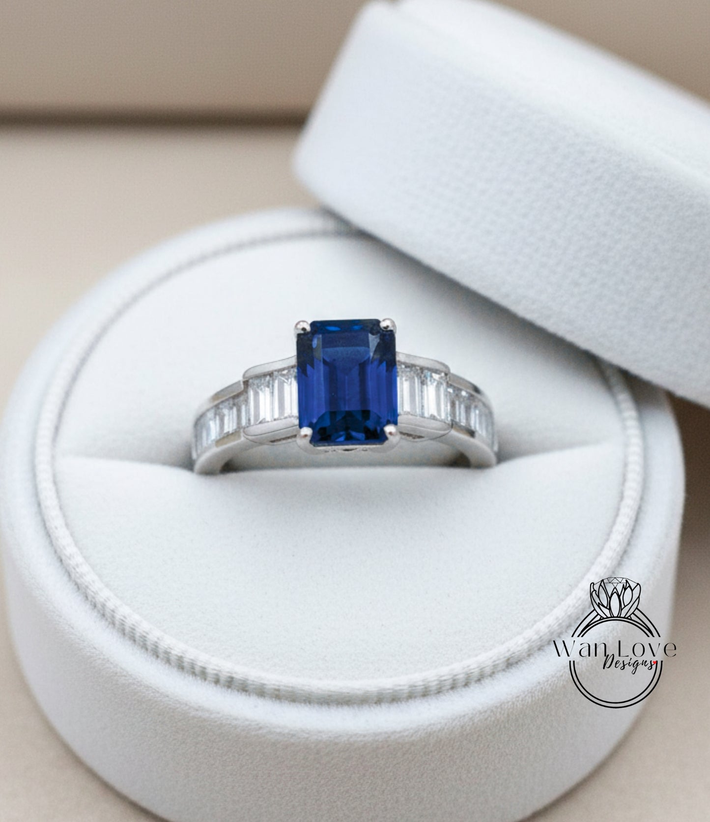 A close-up view of a diamond engagement ring placed in a white jewelry box.