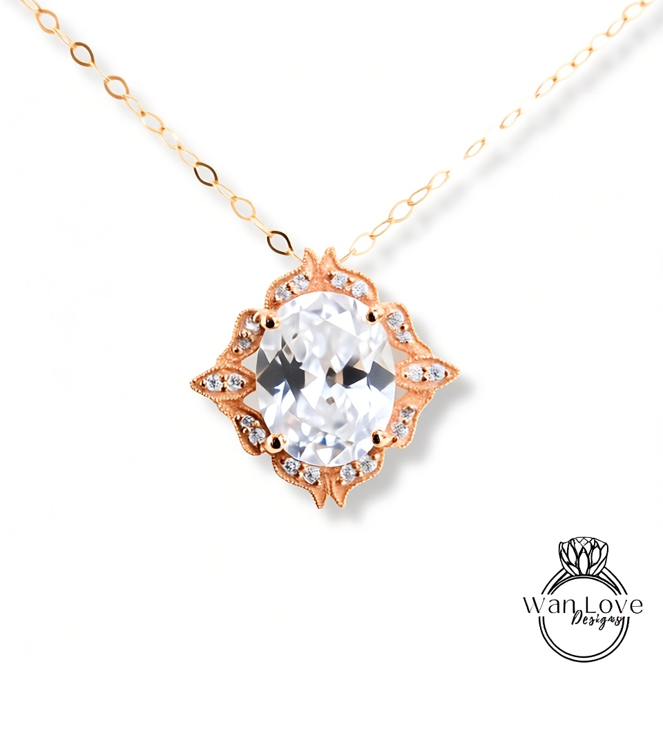 A necklace with a large, clear gemstone pendant, surrounded by an ornate, decorative design.