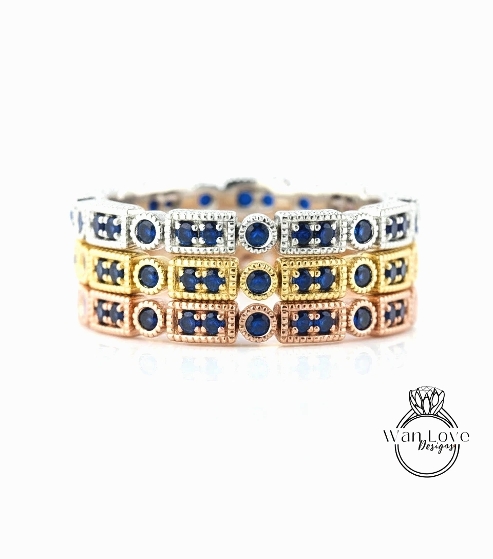 A close-up view of a bracelet with multiple rectangular sections, each adorned with a blue gemstone. The bracelet is set against a white background, highlighting the intricate design and the vibrant colors of the gemstones.