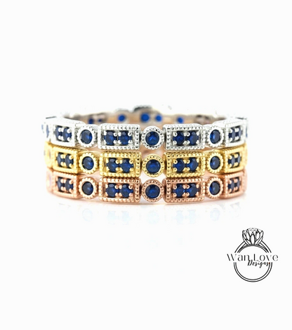 A close-up view of a bracelet with multiple rectangular sections, each adorned with a blue gemstone. The bracelet is set against a white background, highlighting the intricate design and the vibrant colors of the gemstones.