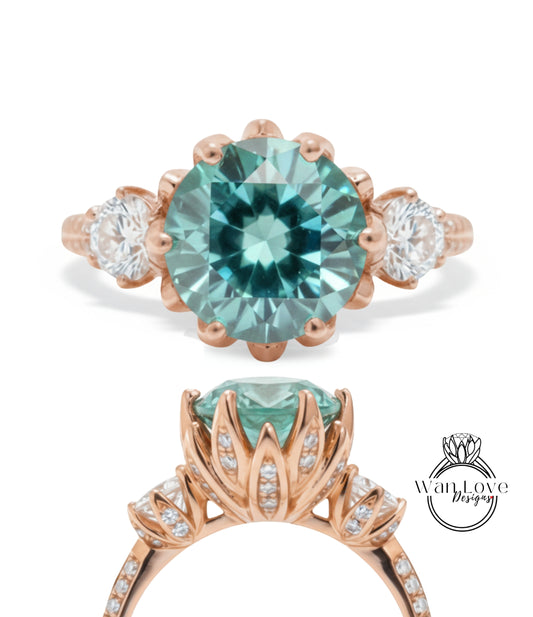 a beautiful engagement ring with a large, round blue gemstone set in a rose gold band. The ring is adorned with smaller diamonds and has a delicate floral design around the gemstone.