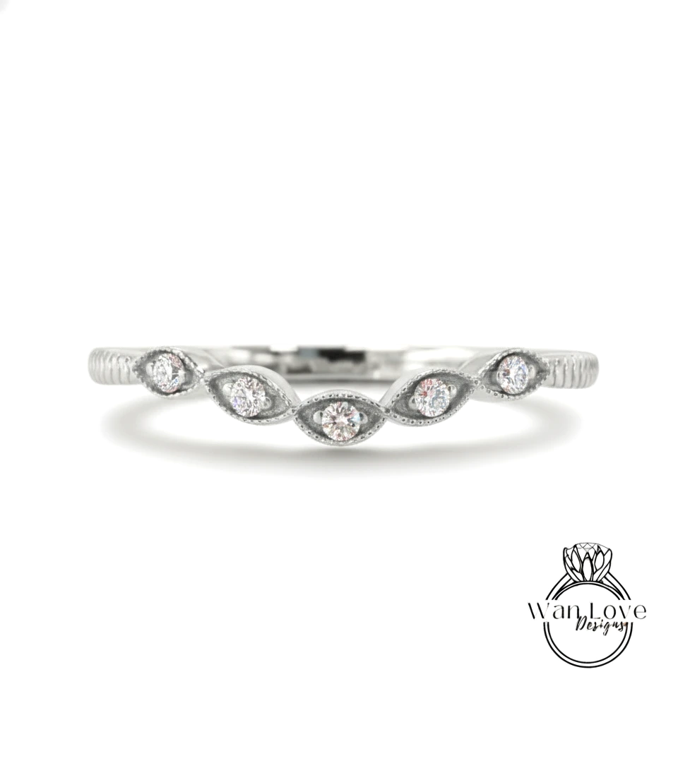 A silver ring with a row of small diamonds set in the center.