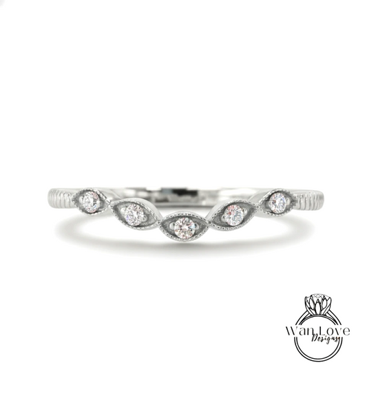 A silver ring with a row of small diamonds set in the center.