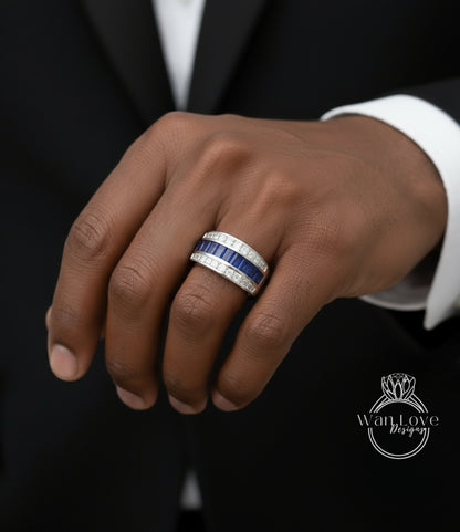 A close-up of a person's hand wearing a ring with blue and white stones.