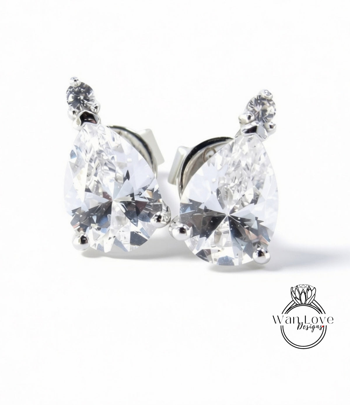 A pair of elegant earrings with large, clear gemstones set in a silver metal frame.