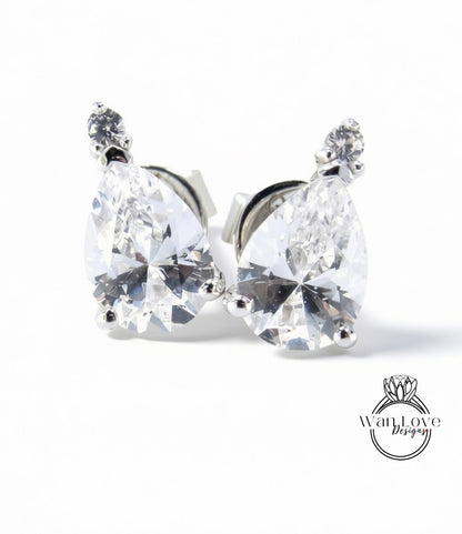 A pair of elegant earrings with large, clear gemstones set in a silver metal frame.