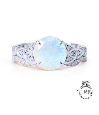 A silver ring with a large, round opal stone set in a decorative band.