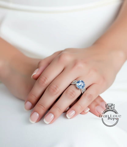 A close-up of a person's hand wearing a ring with a large blue gemstone.