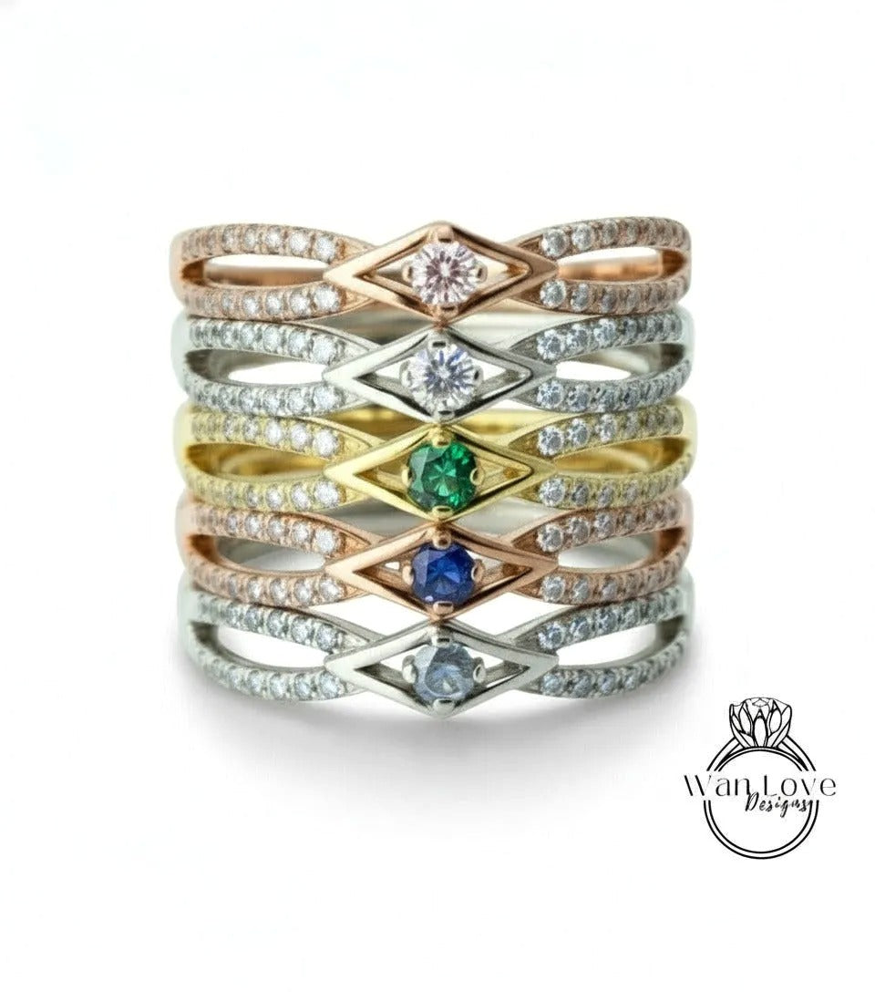 A ring with multiple layers of rings, each ring featuring a diamond and a gemstone. The rings are arranged in a stacked manner, creating a layered effect.