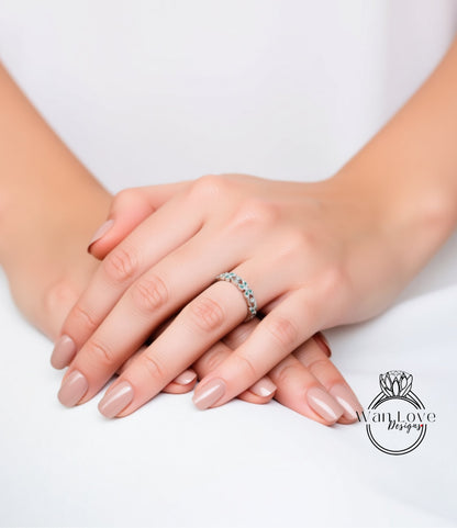 A close-up image of a person's hands wearing a ring on the ring finger.