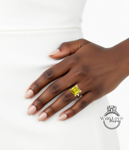 A close-up of a hand wearing a ring with a large yellow gemstone, resting on a white dress.