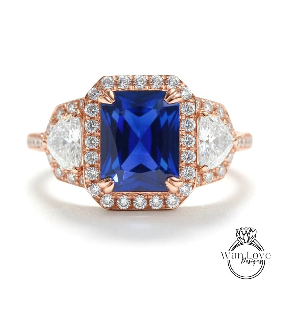 A stunning engagement ring with a large blue gemstone surrounded by smaller diamonds, set in a halo of smaller diamonds.