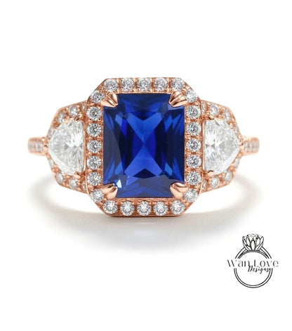 A stunning engagement ring with a large blue gemstone surrounded by smaller diamonds, set in a halo of smaller diamonds.
