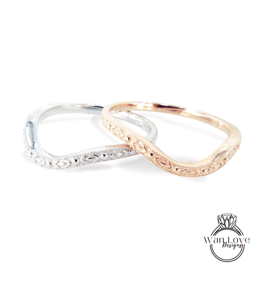 Two ornate rings, one silver and one gold, are displayed against a white background.