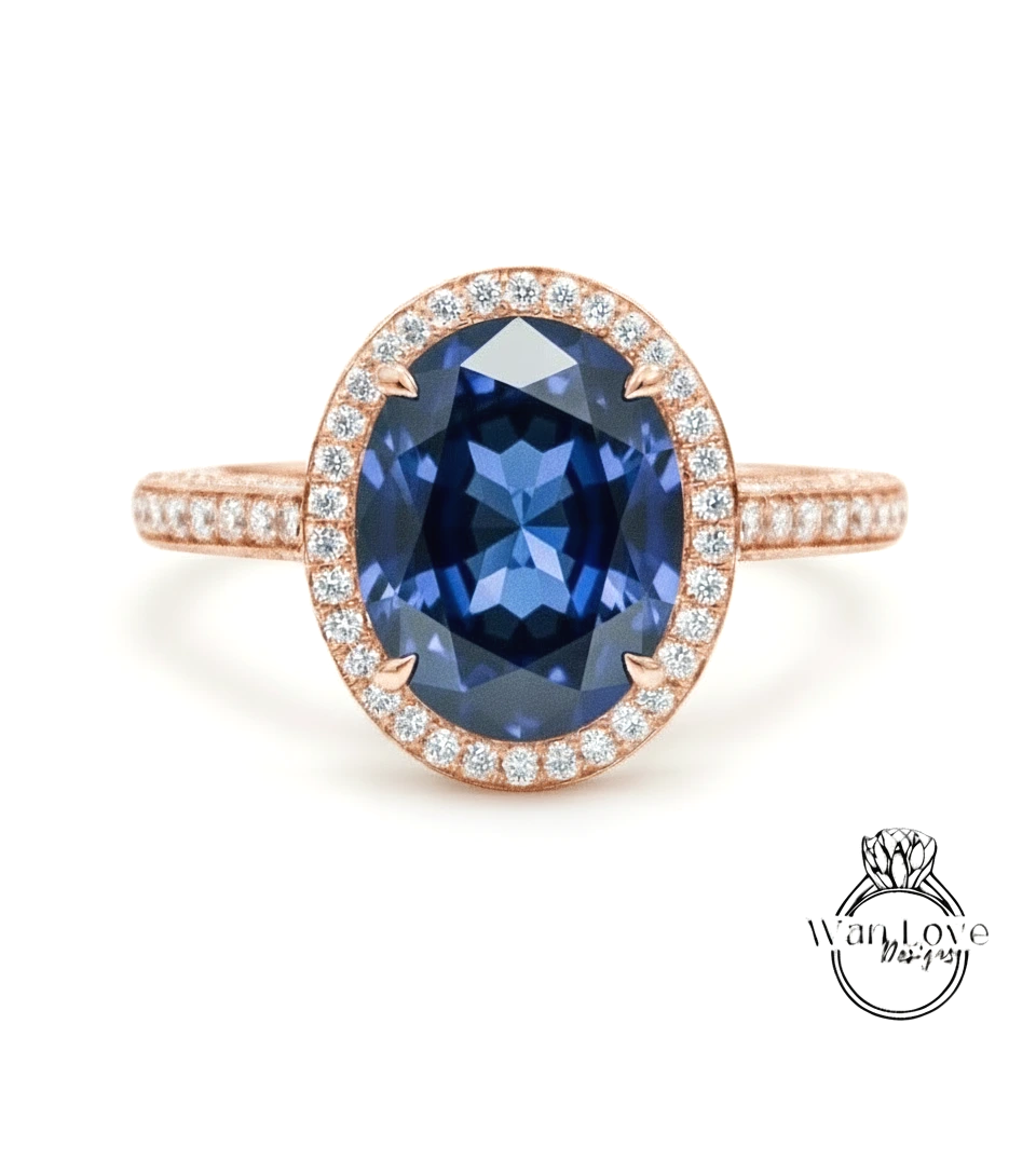 A rose gold ring with a large oval-shaped blue gemstone set in the center, surrounded by smaller diamonds.