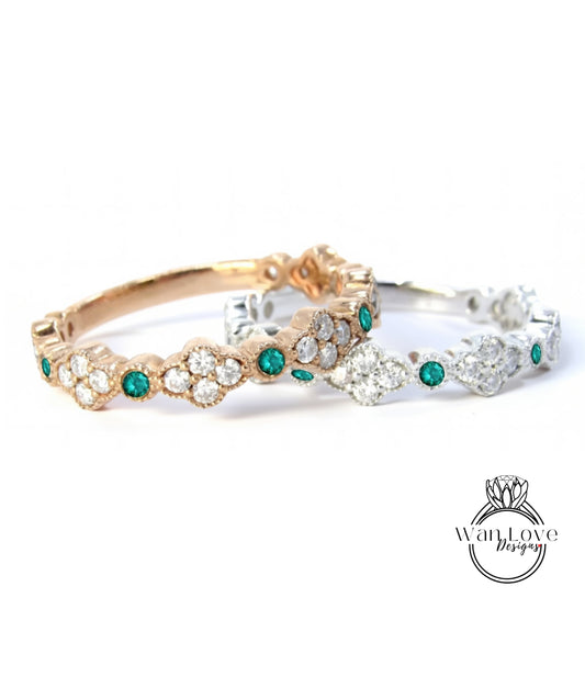 two ornate rings with a combination of gold and silver tones, adorned with green gemstones.
