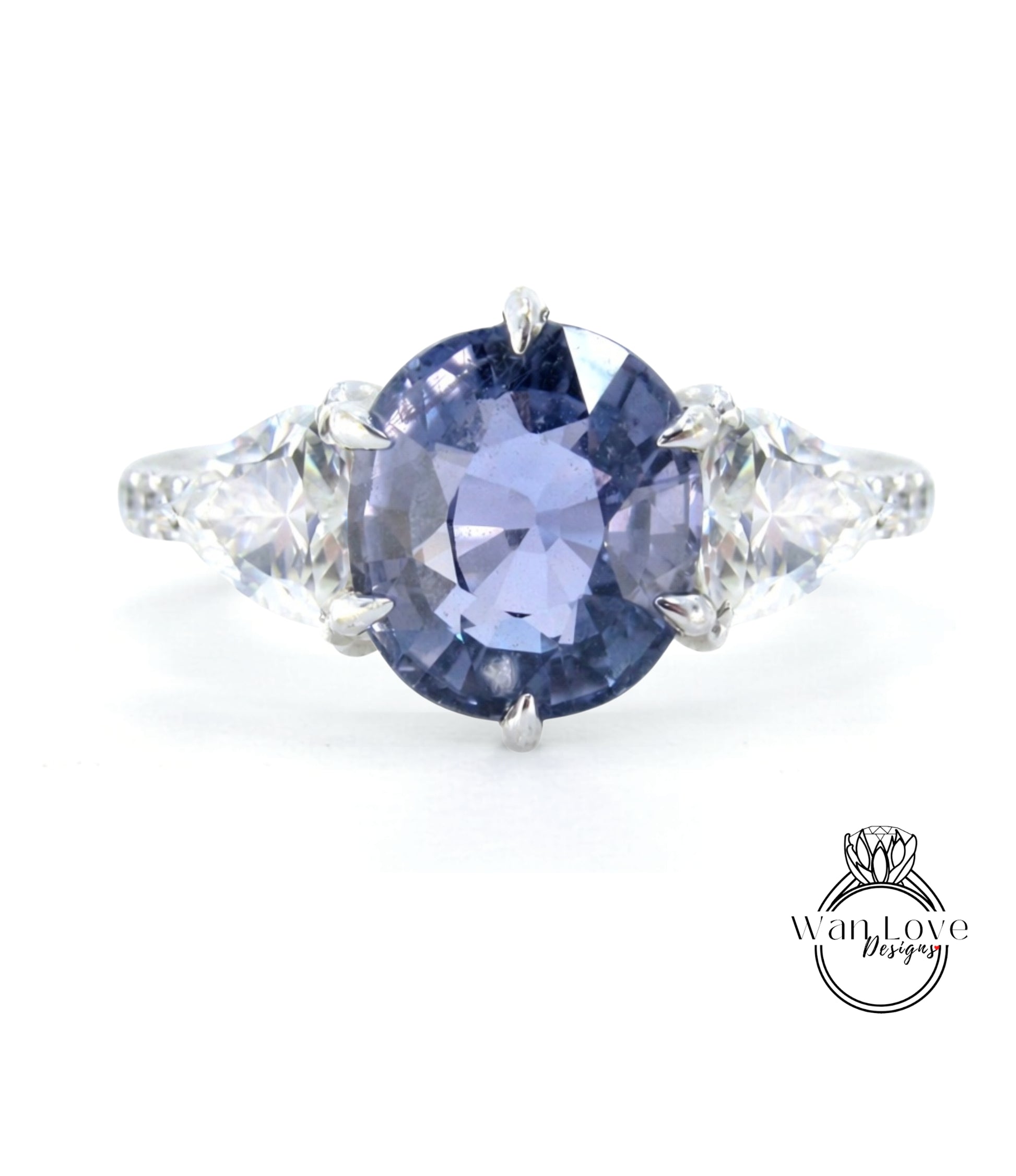 A close-up view of a ring featuring a large, deep blue sapphire gemstone surrounded by smaller diamonds.