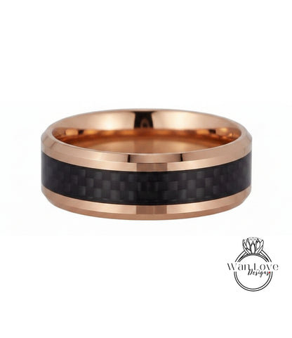 A gold-toned ring with a black carbon fiber band, showcasing a unique and stylish design.
