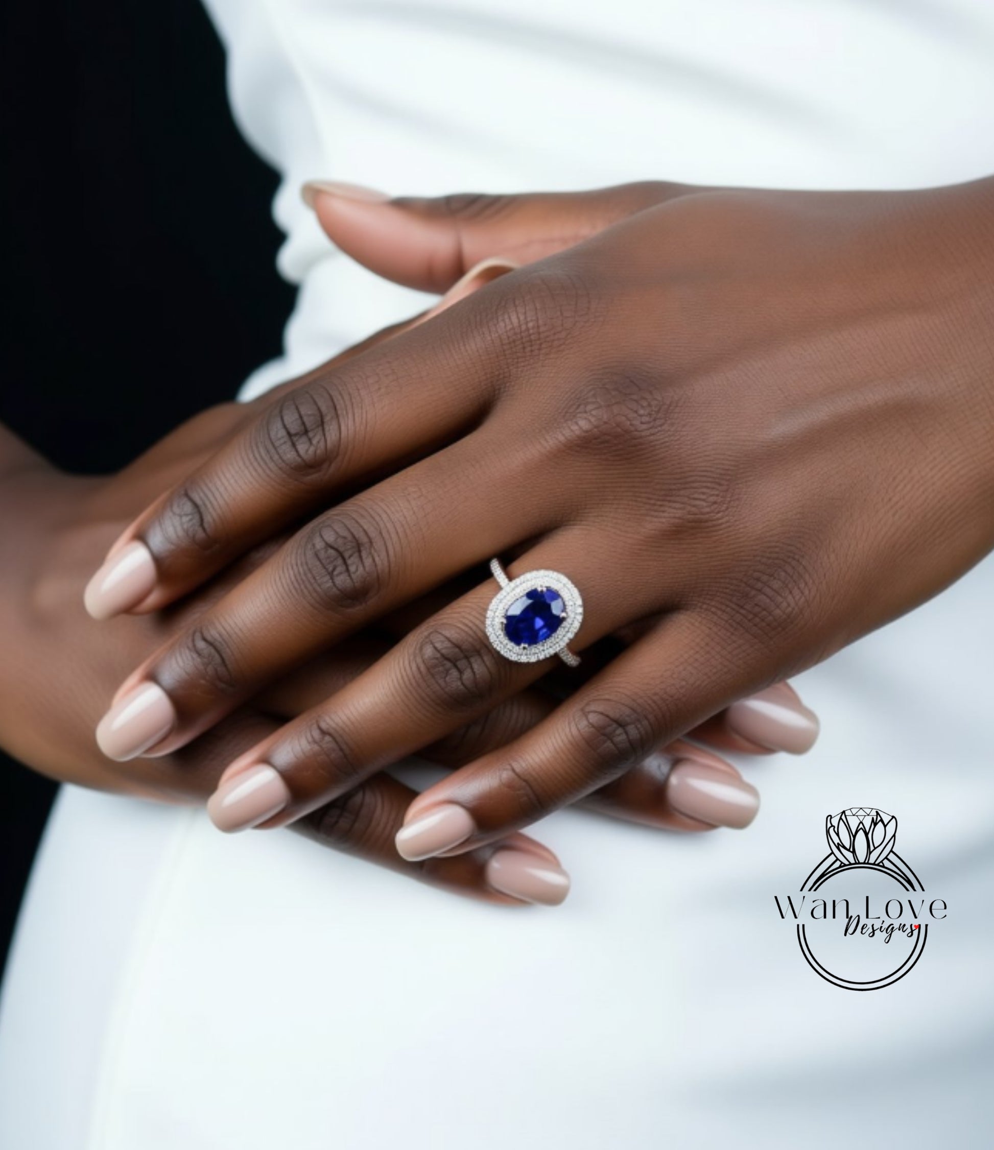 A close-up of a person's hand wearing a large, blue gemstone ring.