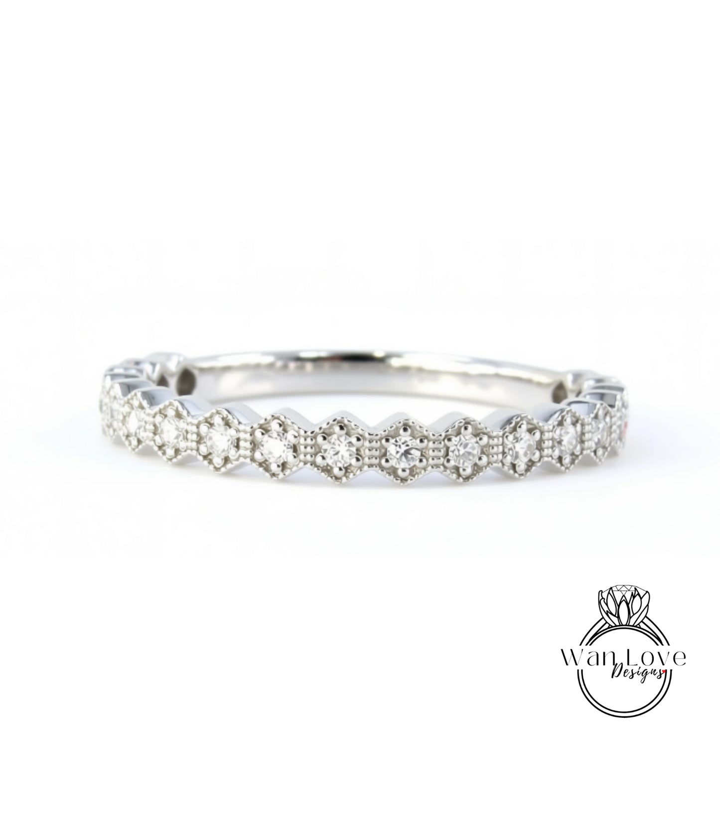 A silver ring with a row of small diamonds set in a hexagonal pattern.