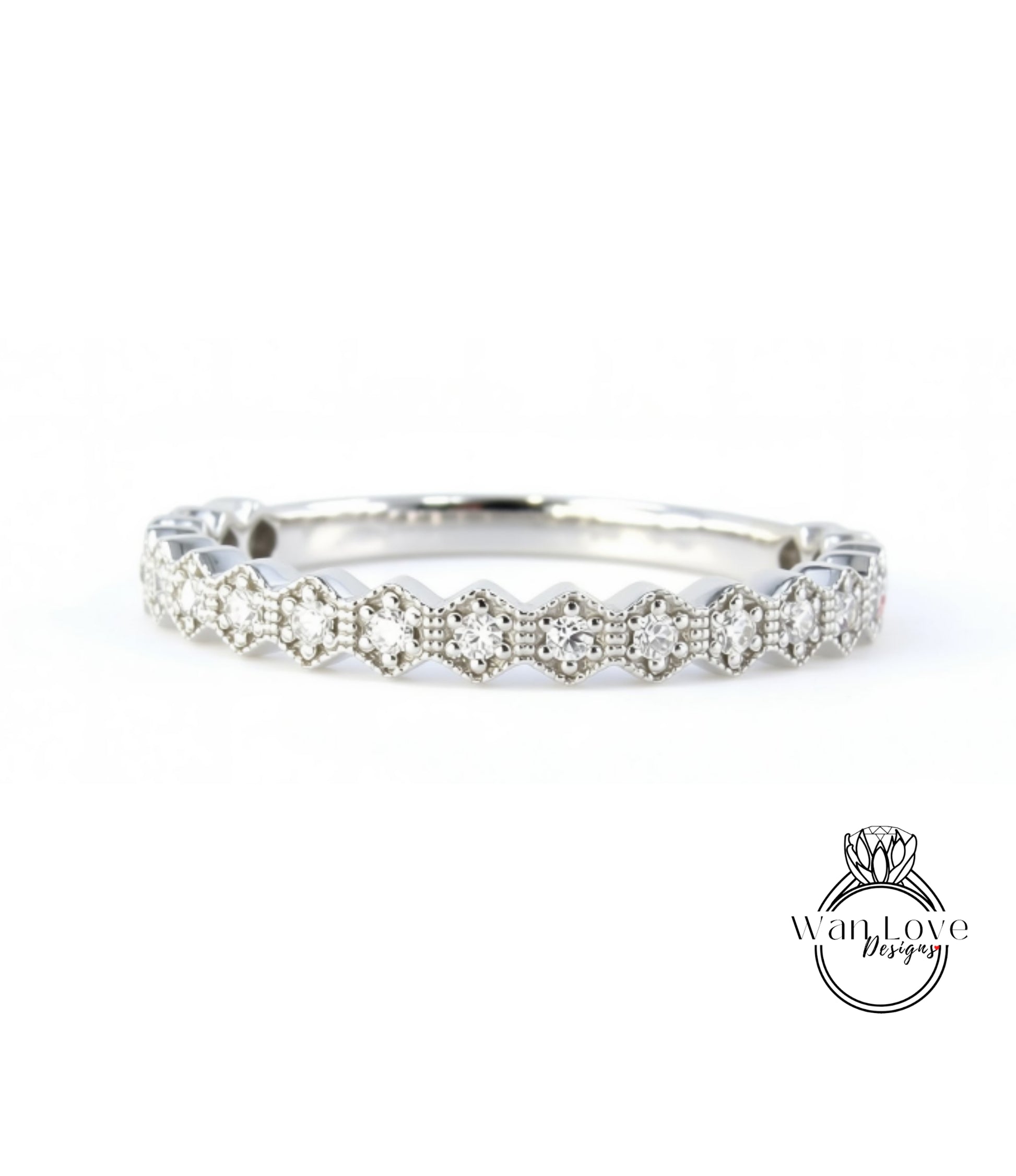 A silver ring with a row of small diamonds set in a hexagonal pattern.