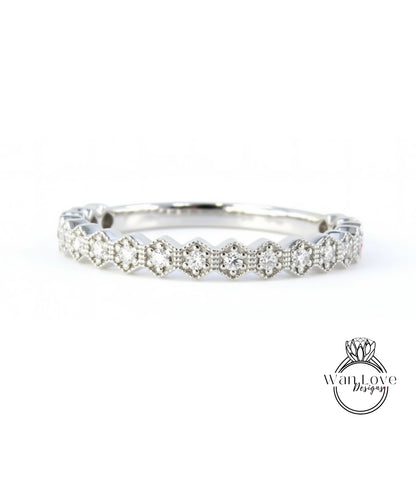 A silver ring with a row of small diamonds set in a hexagonal pattern.
