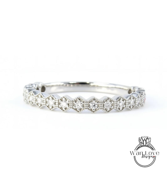 A silver ring with a row of small diamonds set in a hexagonal pattern.