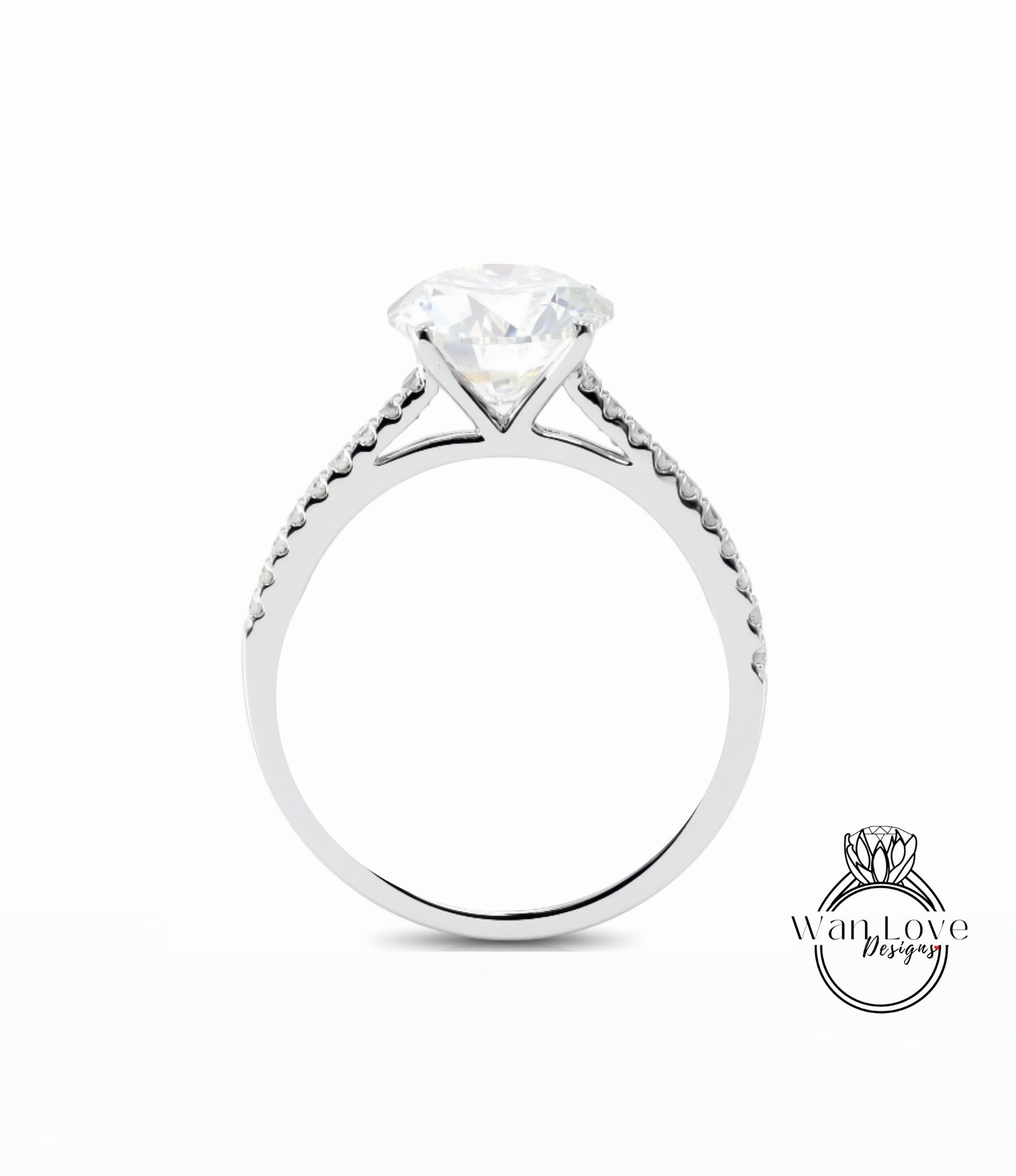 A silver engagement ring with a large diamond set in the center, surrounded by smaller diamonds along the band.