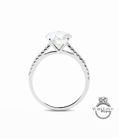 A silver engagement ring with a large diamond set in the center, surrounded by smaller diamonds along the band.