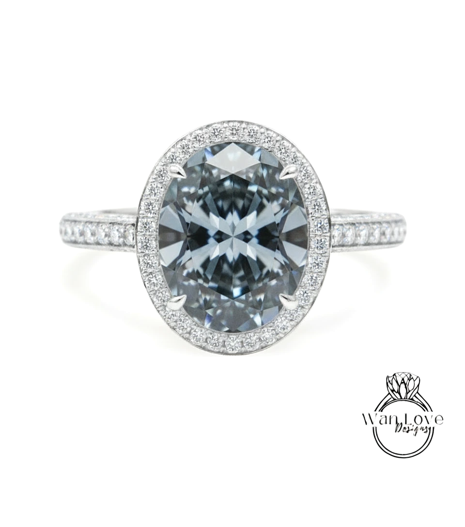 A stunning diamond engagement ring with a large oval-shaped diamond set in a halo of smaller diamonds, surrounded by a band of smaller diamonds.