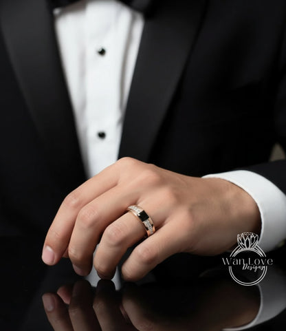 A close-up of a person's hand wearing a gold wedding ring, with a black tuxedo jacket visible in the background.