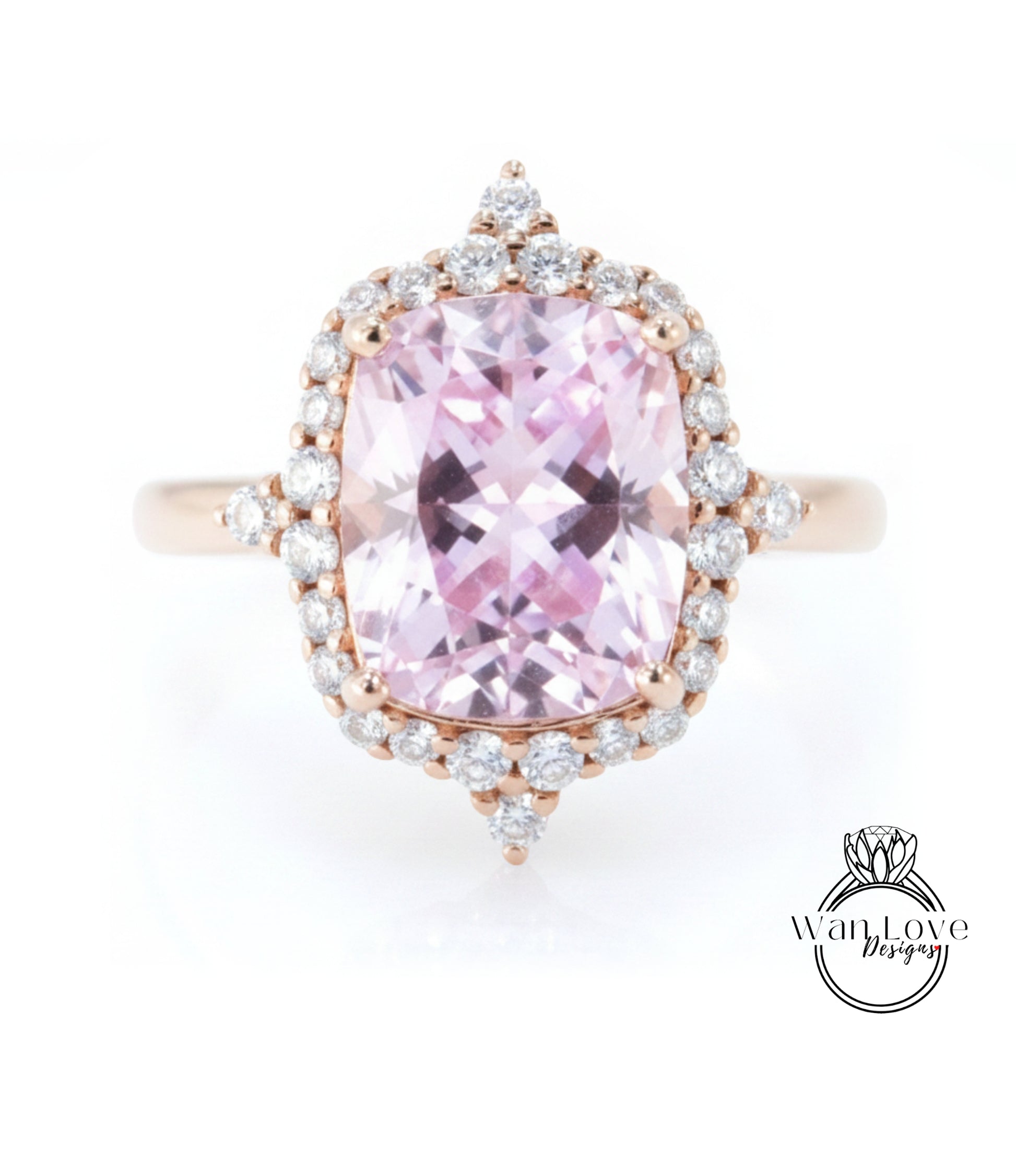 A beautiful pink gemstone ring with a large central gemstone surrounded by smaller diamonds set in a halo of smaller diamonds.