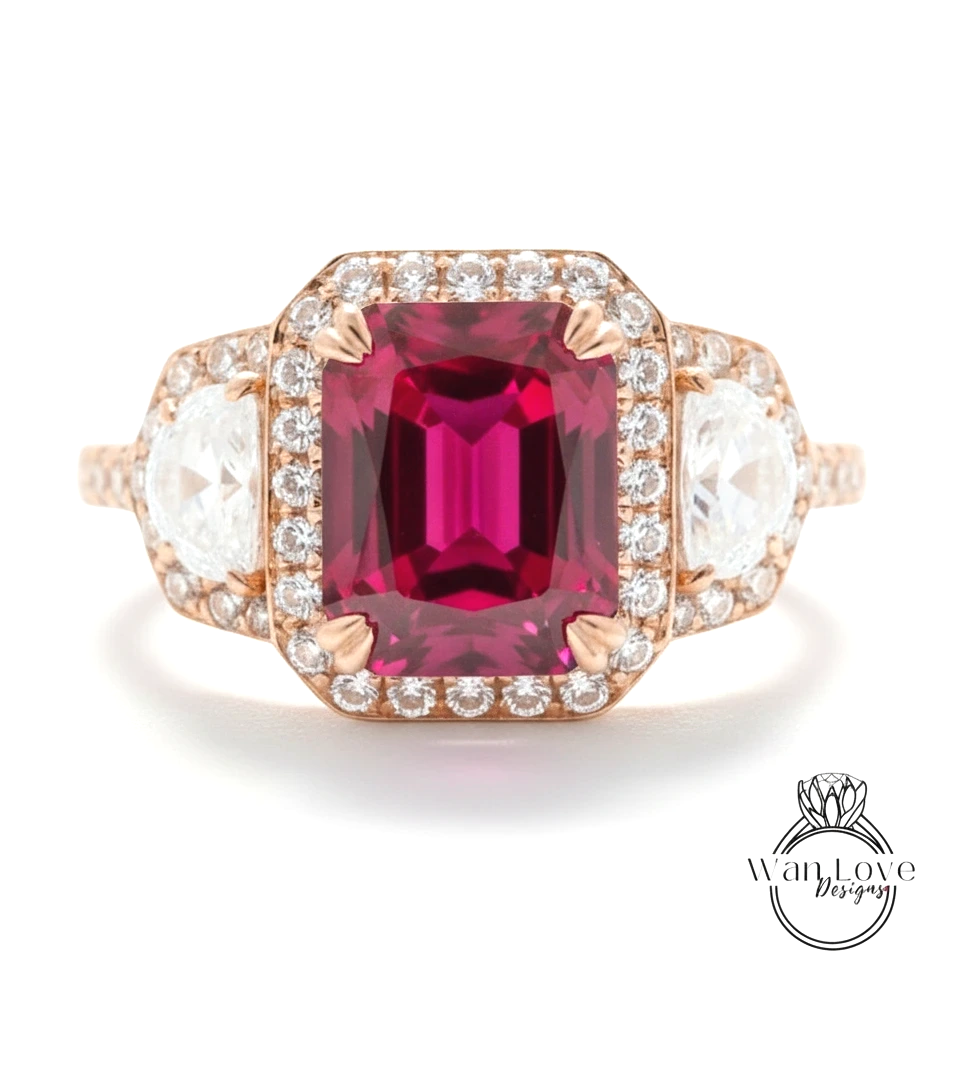 A stunning engagement ring with a large, deep red gemstone surrounded by a halo of smaller diamonds set in a rose gold band.