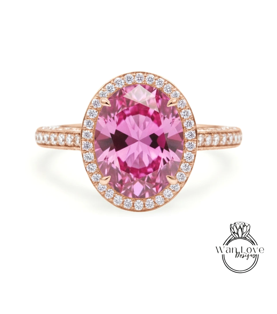 A pink gemstone ring with a halo of smaller diamonds around the center stone.