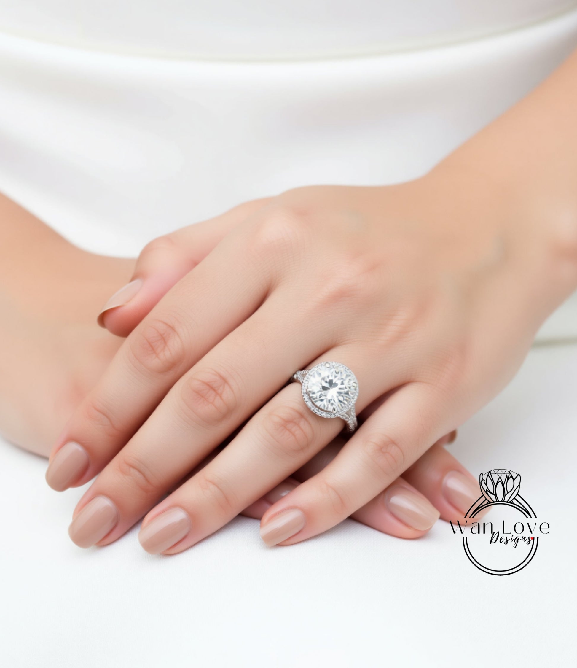 A close-up of a person's hand wearing a large, sparkling diamond ring.