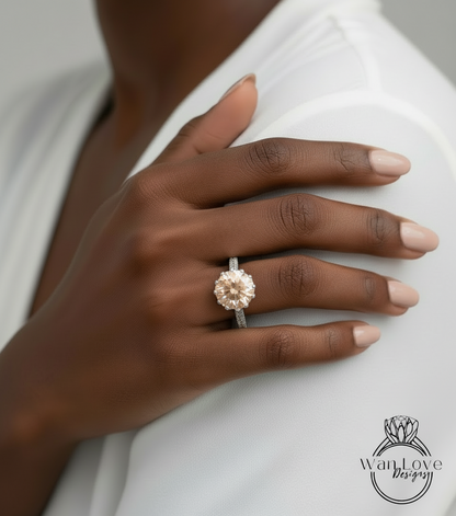 A close-up of a person's hand wearing a large, ornate diamond ring on the ring finger.
