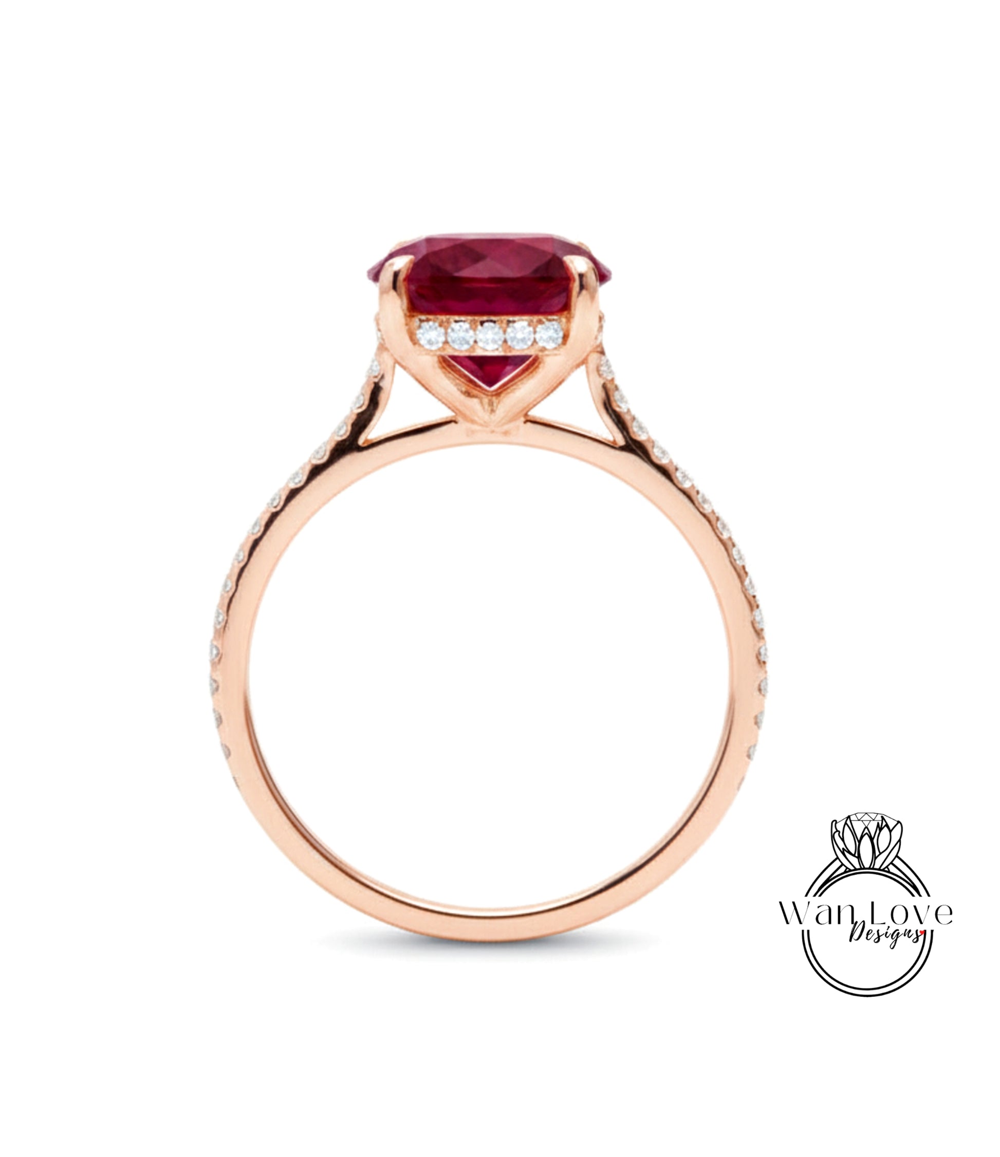 A rose gold engagement ring with a large red gemstone and small diamonds set in the band.