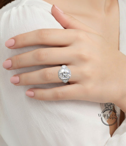 A close-up of a person's hand wearing a large, sparkling diamond ring on the ring finger.
