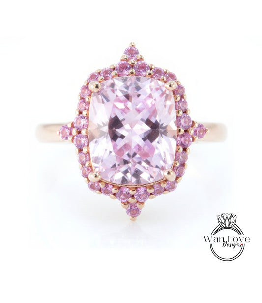 A pink gemstone ring with a large central gemstone surrounded by smaller pink gemstones.