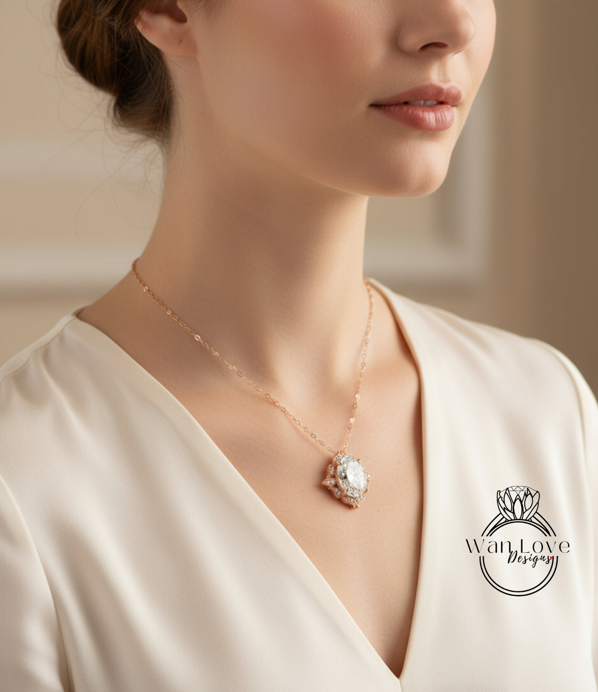 A close-up of a woman wearing a necklace with a pendant, and a logo on her blouse.