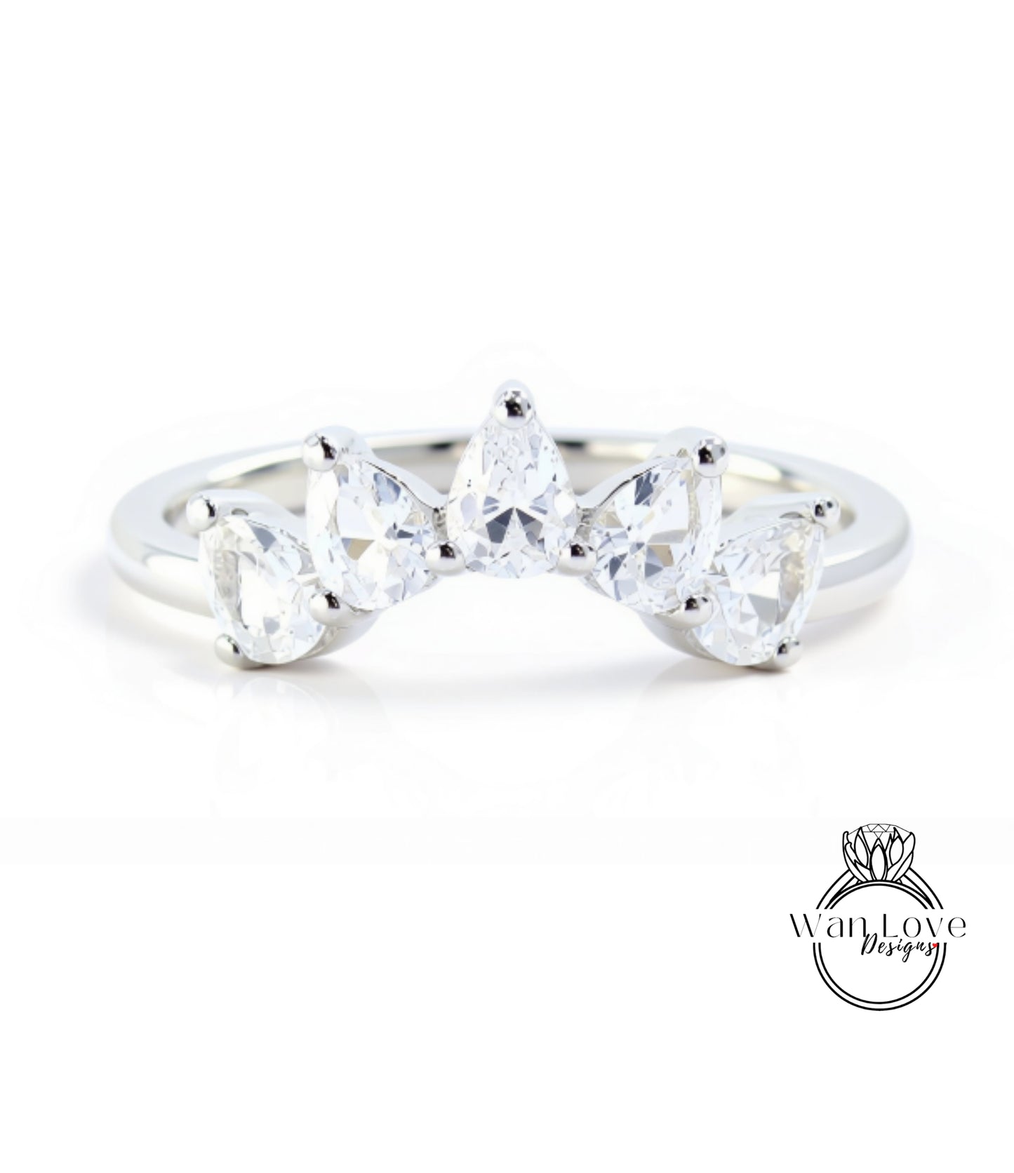 A silver ring with a unique design featuring a row of clear gemstones, including pear-shaped and round-shaped stones, set in a band.